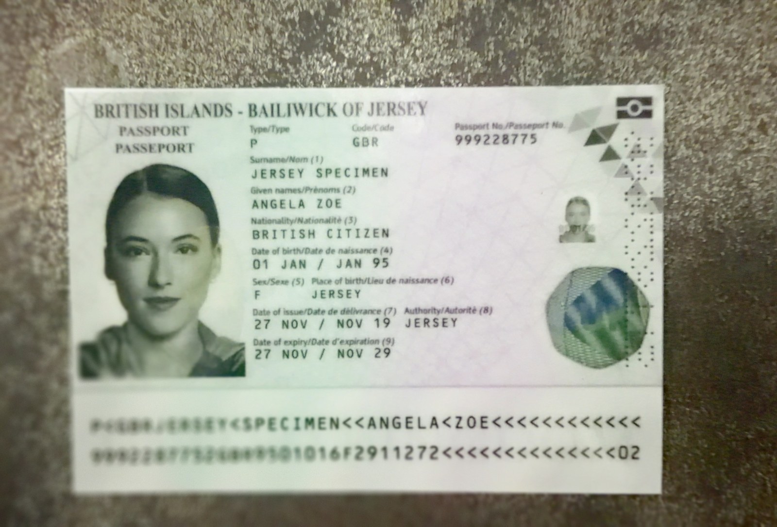 A photographed specimen passport page that is sharp in the center but out of focus in the lower-left corner, where the start of the MRZ lines is unreadable
